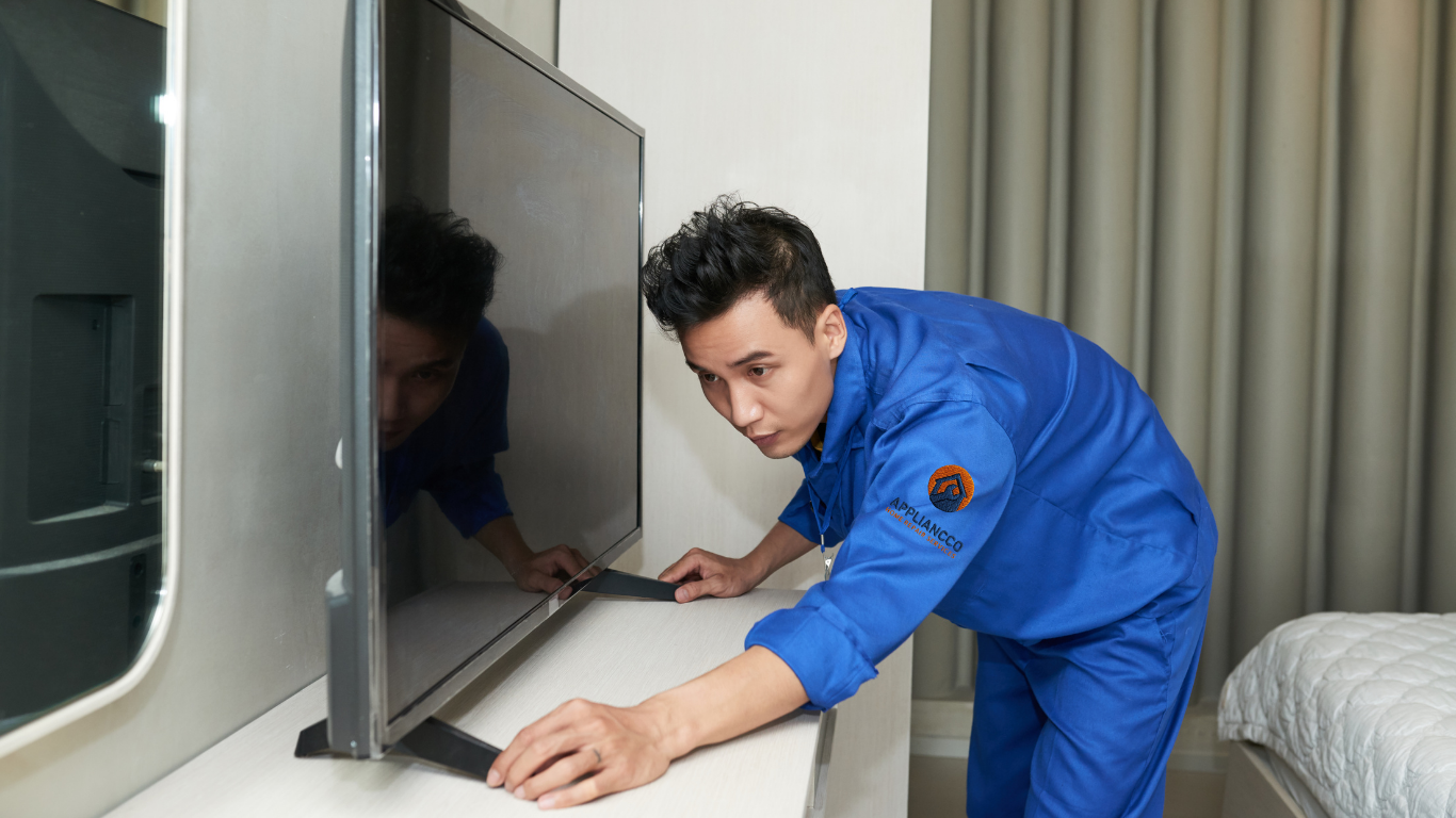 technician installing smart TV wall mount in modern living room